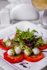 Mozzarella with tomatoes and pesto sauce