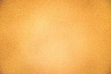 Abstract background made of foam sponge, painted in gold color. Uneven surface. Festive texture.