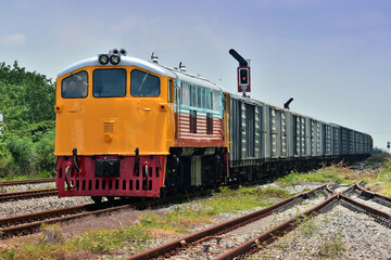 Fototapeta na wymiar Freight train by diesel locomotive on the railway in Thailand