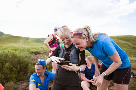 Friends looking at smart phone while hiking