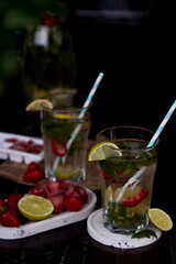Summer infused water with lemon, lime, mint and strawberries. Refreshing, diet, detox natural fortified water. Hard seltzer with nootropics. Healthy natural cocktails. Summertime beverages