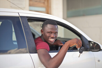 young man in car with key in hand