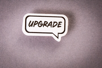 Upgrade, communication concept. Speech bubble on gray background