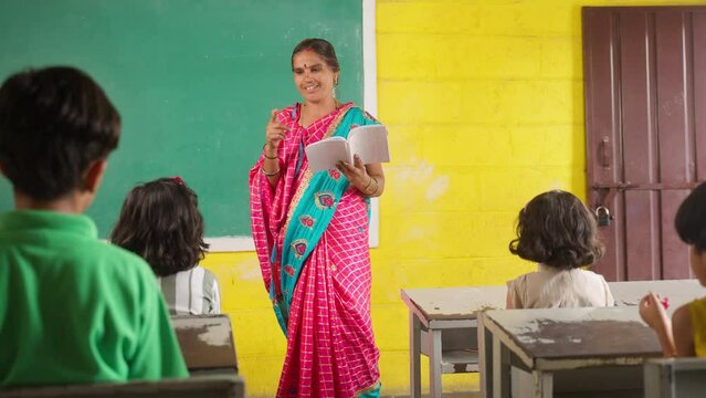 teacher taking class to elementary school students at classroom - concpet of woman empowerment, back to school and education.