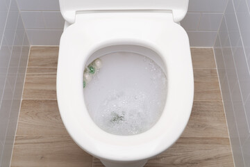 Water flushing in toilet bowl with sanitizing wc balls. - obrazy, fototapety, plakaty