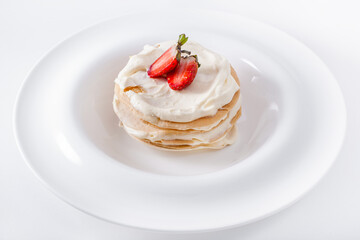 Pancakes with white cream and strawberries