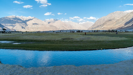 Hunder, Leh Ladakh, India - Hunder village in the Leh Nubra valley of Ladakh is famous for Sand dunes, Bactrian camels. Tourists love spend time by the river