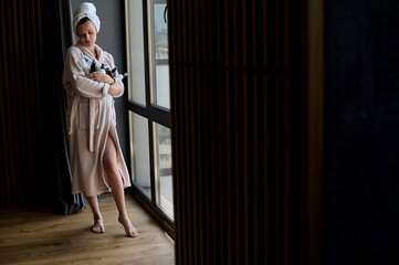 Portrait of a beautiful pregnant woman in bathrobe and towel wit
