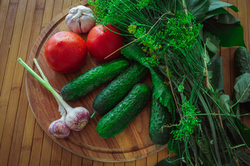 Fresh vegetables on a wooden table. Greens and dill for pickling vegetables.