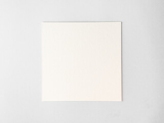 empty square cardboard sheet on a white table. empty space for text