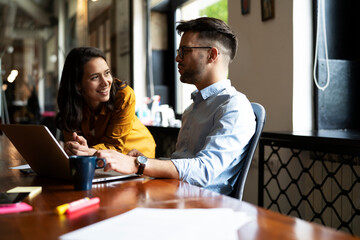 Colleagues in office. Businesswoman and businessman drinking coffee.