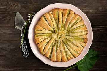 Rhubarb pie, top view on dark wooden background