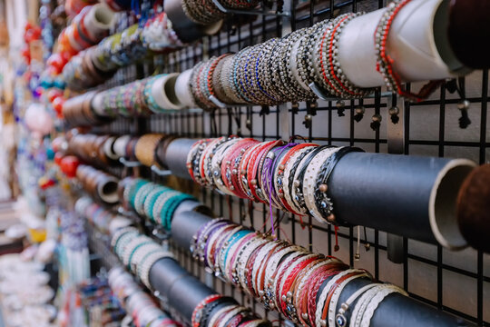 Trendy handmade bracelets and wristbands for sale at artisans market. Handcraft souvenir at flea market. Purchase of elegant souvenirs