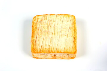 A square of Le Roussot cheese on a white background. Le Roussot is a Carré des Vosges, a soft, square-shaped cheese with the full taste that is typical of the local mountain region.