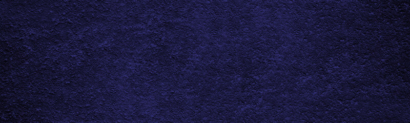 Navy blue old textured plaster wide surface. Indigo color rough cement panoramic texture. Dark abstract dramatic gloomy background