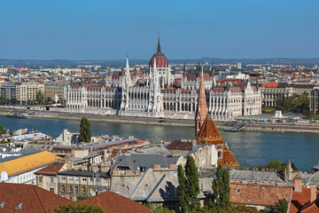 Fototapeta na wymiar Budapest, Hungary. View on the Hungarian Parliament Building from Castle Hill. Dome and tower of Calvinist Church are visible in the foreground.