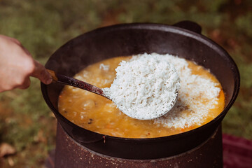 Recipe for traditional oriental pilaf in a cauldron in nature. Cooking. Recipes. Step-by-step photo instructions for cooking pilaf. 