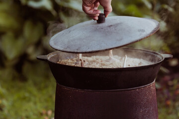 Recipe for traditional oriental pilaf in a cauldron in nature. Cooking. Recipes. Step-by-step photo...