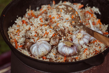 Recipe for traditional oriental pilaf in a cauldron in nature. Cooking. Recipes. Step-by-step photo...