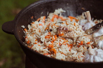 Recipe for traditional oriental pilaf in a cauldron in nature. Cooking. Recipes. Step-by-step photo...
