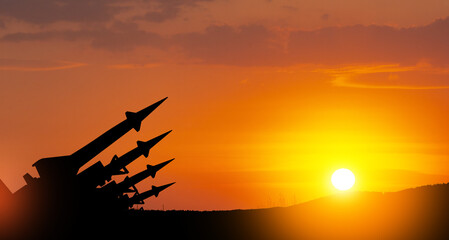 The missiles are aimed at the sky at sunset. Nuclear bomb, chemical weapons, missile defense.