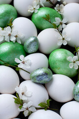 Colorful Easter eggs with spring blossom flowers isolated over white background. - 516936392