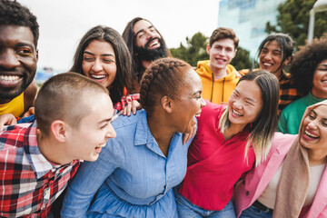 Young diverse people having fun outdoor laughing together - Focus on african curvy girl face