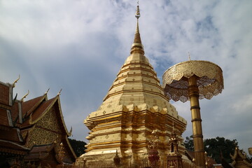golden minaret building in temple in thailand