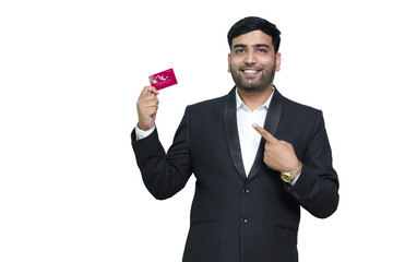 Young smiling man in pointing on credit card.