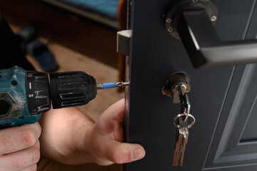 Installation of lock and door handle to interior doors, locksmith works with doors.