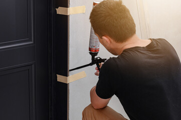 The use of mounting foam with a spray gun in construction works, installation of interior doors.