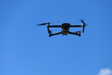 Gray quadcopter in flight. Photo-video aerial photography.