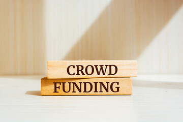 Wooden blocks with words 'Crowdfunding'.