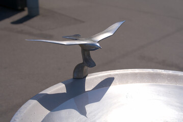 Shiny silver metal seagull at fountain at Bellevue Square at City of Zürich on a hot summer noon. Photo taken June 19th, 2022, Zurich, Switzerland.