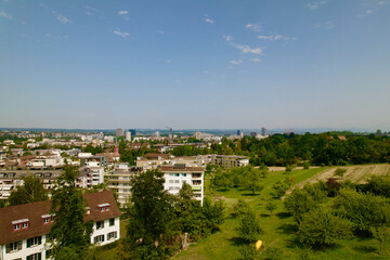Fototapeta na wymiar Aerial view over City of Zürich seen from district Schwamendingen on a sunny hot summer day. Photo taken June 21st, 2022, Zurich, Switzerland.