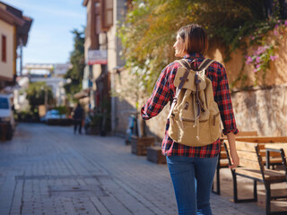 travel to Turkey, old town Antalya Kaleci Famous tourist destination . Happy asian female tourist traveller with backpack walks in old city. - obrazy, fototapety, plakaty