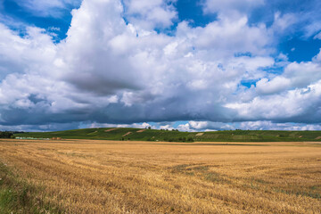 View over a harvested grain field towards vineyards in the background in Rhenish-Palatinate/Germany