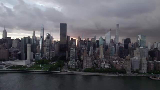 Aerial view of the riverside of Midtown East, gloomy evening in NYC, USA - pan, drone shot