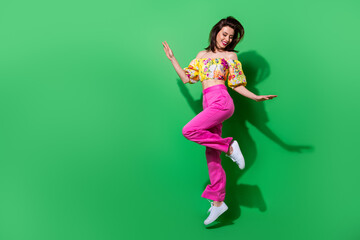 Full length photo of cheerful positive girl dressed off shoulders top jumping high empty space...