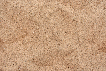 Fototapeta na wymiar The texture of beautiful coarse sea sand with small pebbles and particles of shells. Yellow sand. sharp sand.