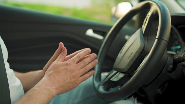 Man driving in innovative automated car using self-parking autopilot for parking on parking lot