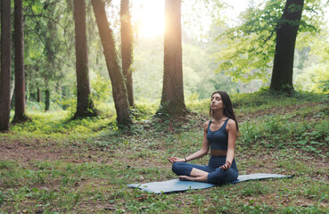 Woman practicing meditation in the forest