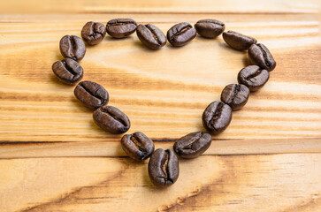 Serce z ziaren kawy na deskach. Kawa ziarnista. Zakochany w kawie. Miłośnicy kawy. Kocham kawę.
