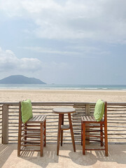 Outdoor cafe with tables and chairs at the beach, perfect summer vacation