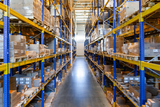 Interior of a modern warehouse storage with rows and goods boxes on high shelves