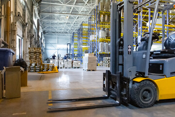 Interior of a modern warehouse with forklifts. Pallet stacker truck equipment at warehouse. Forklift loader