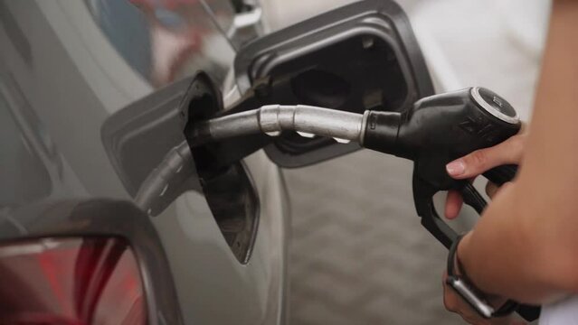 Gas Station Gas Pump Close Up Pump Nozzles At Gas Station Young Beautiful Woman Driver Fills The Car With Gasoline