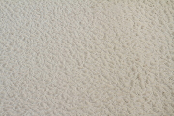 Ripples left in sand at a seaside	
