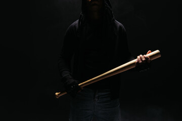 Cropped view of african american vandal holding baseball bat isolated on black - obrazy, fototapety, plakaty