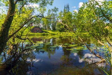 Fototapeta premium A blacksmith shop on the shore in the Priyutino estate. Vsevolozhsk. Leningrad region.